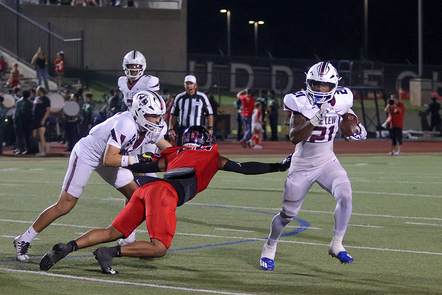 Running back Viron Ellison sneaks past Coppell defensive end Diallo Hall during the football game aginat Coppell on Sept. 29. The Farmers lost their 5-year winning streak against the Cowboys with a 49-28 loss.