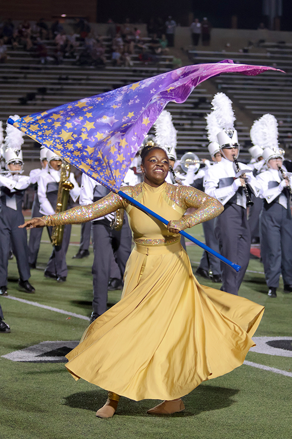 Color guard squad leader Olivia Small dances to the Constellations competition performance alongside the band. 