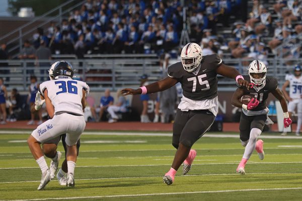 Senior offensive lineman Xavion Davis looks to block Plano West defenders to make space for senior running back Viron Ellison during the Plano West football game. 