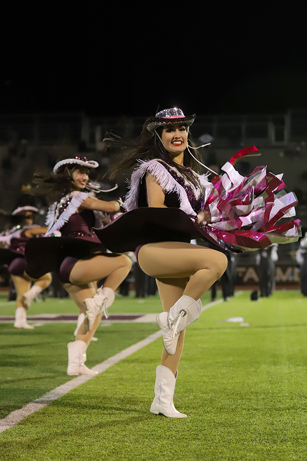 Social officer Milka Ruiz uses streamers as she performs during the homecoming game. Ruiz danced with the varsity Farmerettes to Dynamite. 