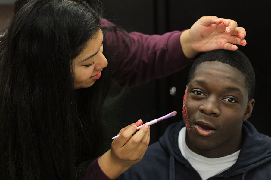 During last years Halloween Carnival, 2023 graduate Kaley Gomez paints senior Oreoluwa Olayinkas face. Gomez worked a face painting stand and painted Spiderman on Olayinka.