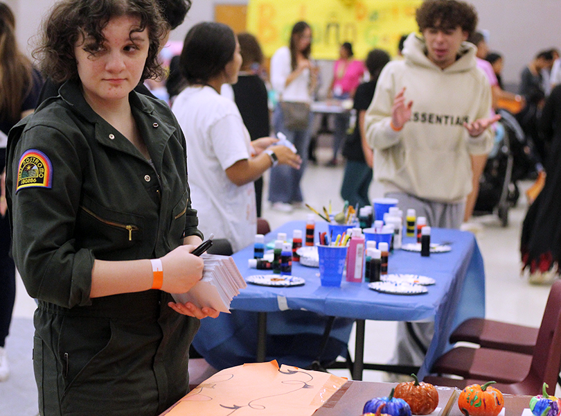 Senior Eleanor Power works the National Honor Society pumpkin painting booth. 
