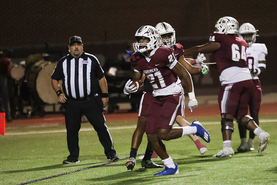 Senior running back Viron Ellison (21) runs the ball into the end zone scoring a touch down. This extended the lead to 15-3 against the Plano Senior Wildcats.