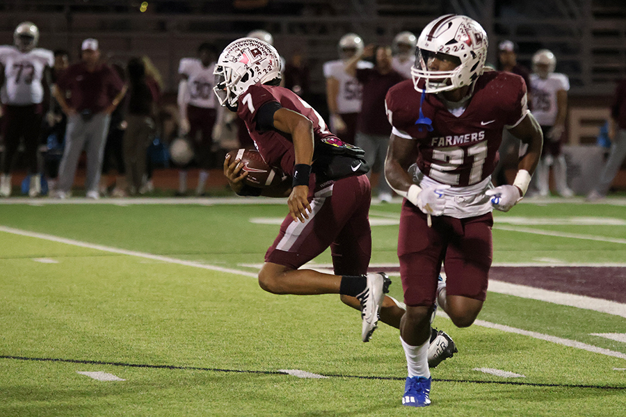 Senior quarterback Ethan Terrell (7) runs away from senior running back Viron Ellison (21) after a fake snap during the homecoming game against Plano Senior High School last Friday.