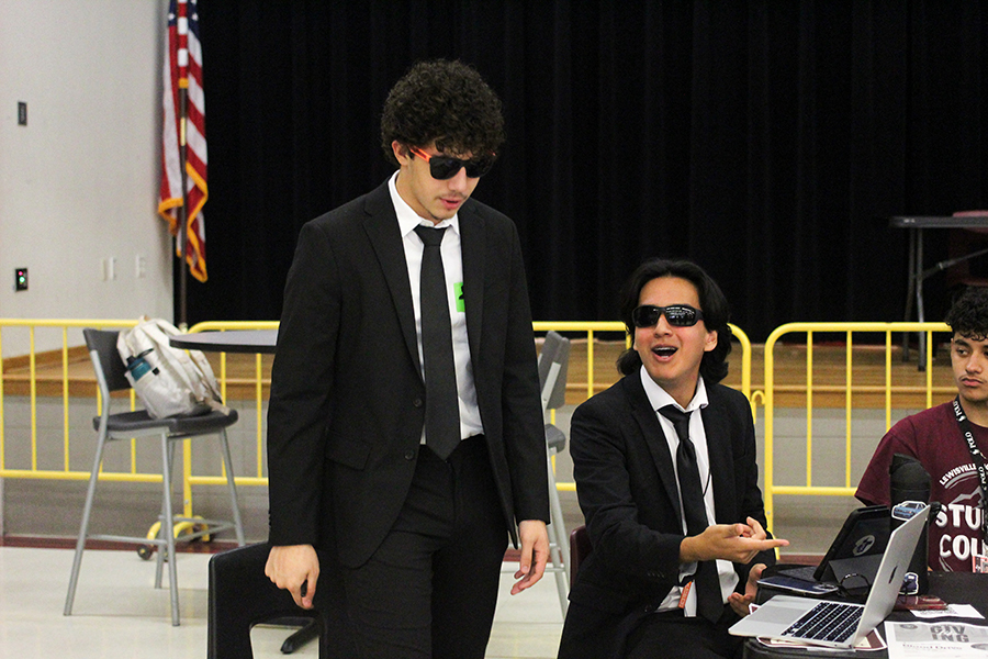 Seniors Antonio Naves, and Chris Gallegos both dress up in tuxedos and sunglasses.