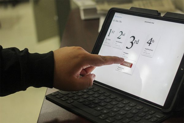 A student checks into class using the pass-o-matic system.