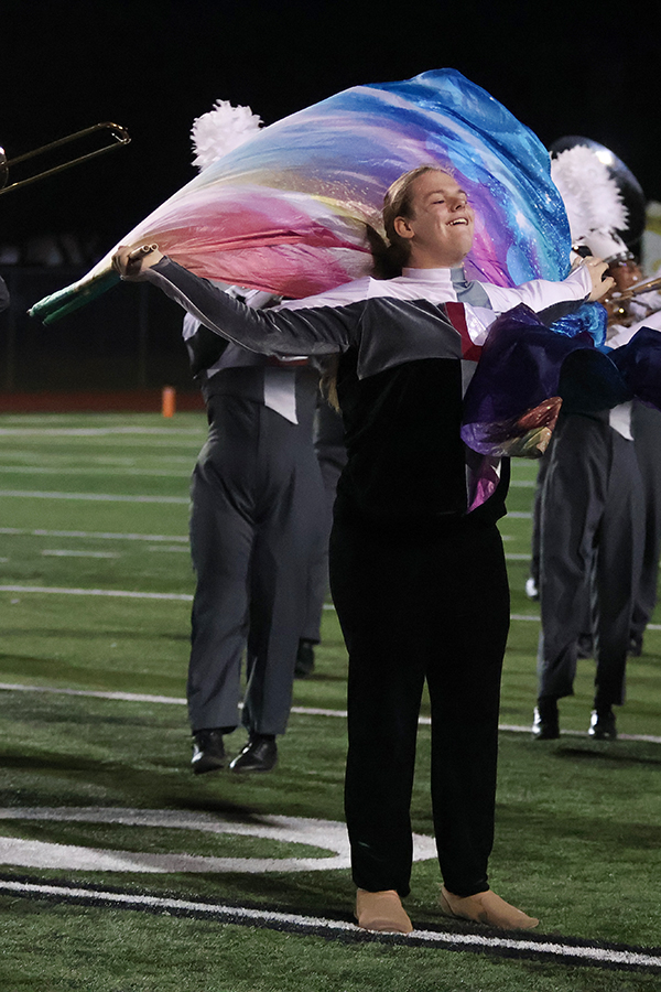Colorguard member Drew Ranck performs with his flag during the bands performance of the Hebron halftime show.