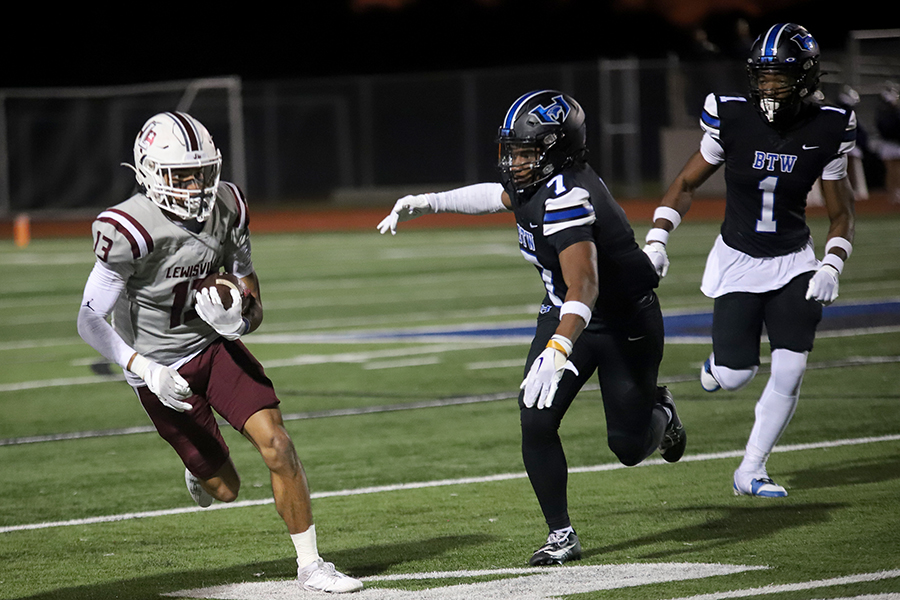 Wide receiver Julian JJ Gonzales rushes the ball past Hebron defensive player Dylan Goodrich during the first quarter of the Hebron game. The Farmers took away their last regular season win with a 32-10 score. 