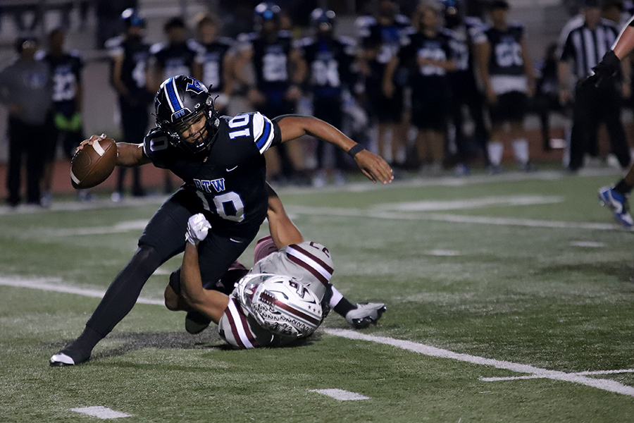 Defensive lineman Sean Oliver tackles Hebron quarterback Patrick Crayton in the game against Hebron. After their loss to the Farmers, the Hawks did not advance to the playoffs.