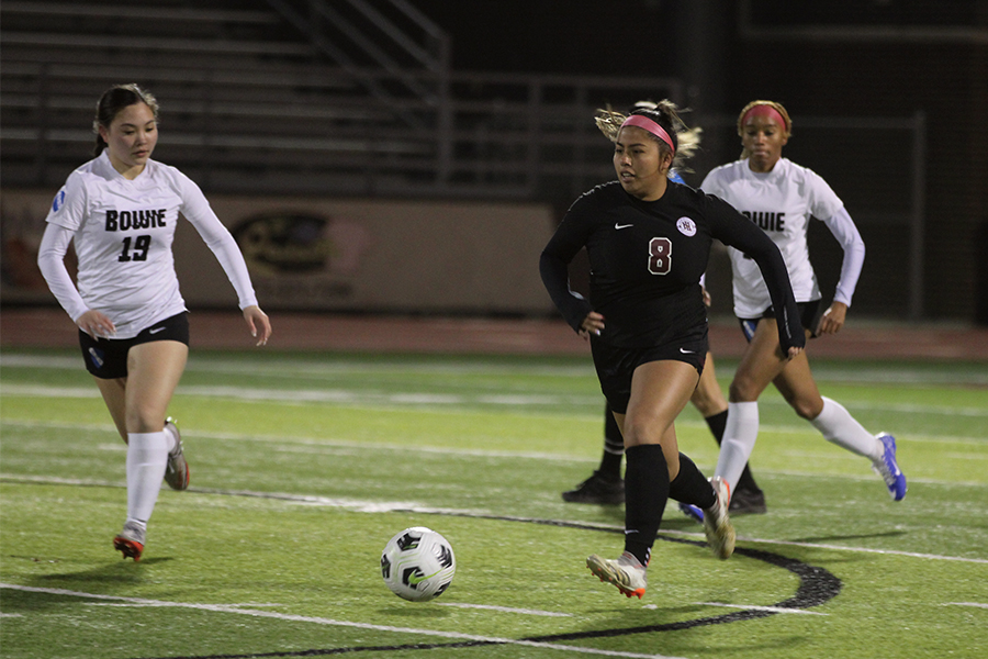 Junior Sofia Flores runs the ball down the field during the game against Arlington Bowie on Jan. 9.