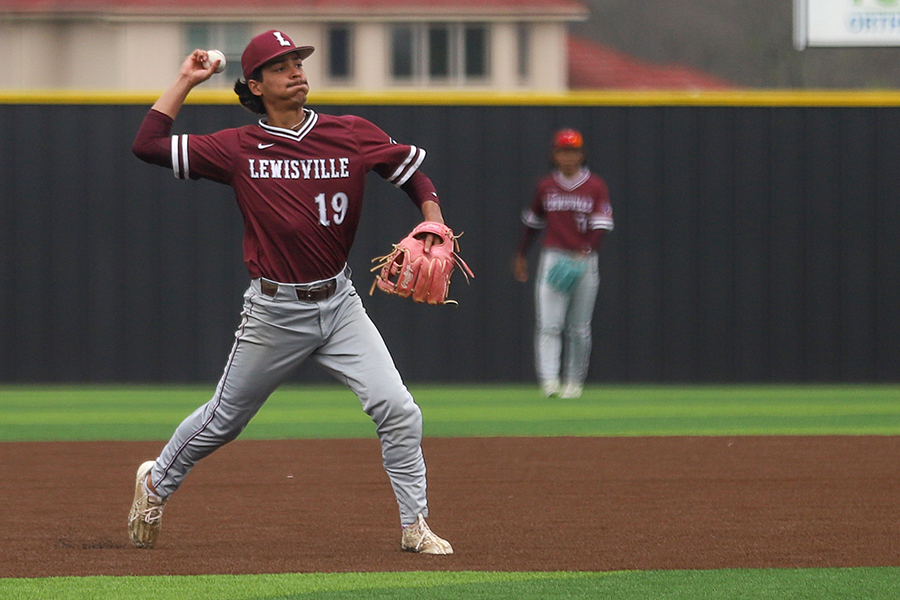 Senior Angel Cuevas throws to first base in a game against Plano East on Friday, March 15. 