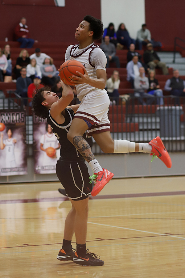 Senior Rakai Crawford (2) goes for a layup at the game against Coppell on Jan. 23.