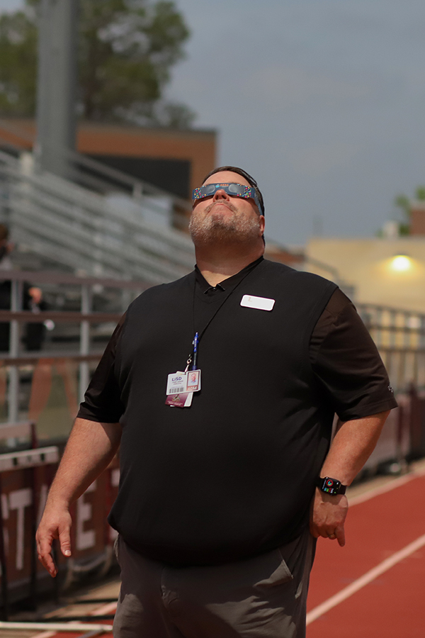 After totality passes, principal Jim Baker watches the final moments of the eclipse before everyone heads back inside for fourth period.