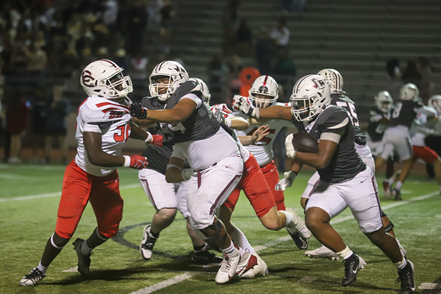 Freshman Maxx Jones blocks for senior Isaiah Wilson.