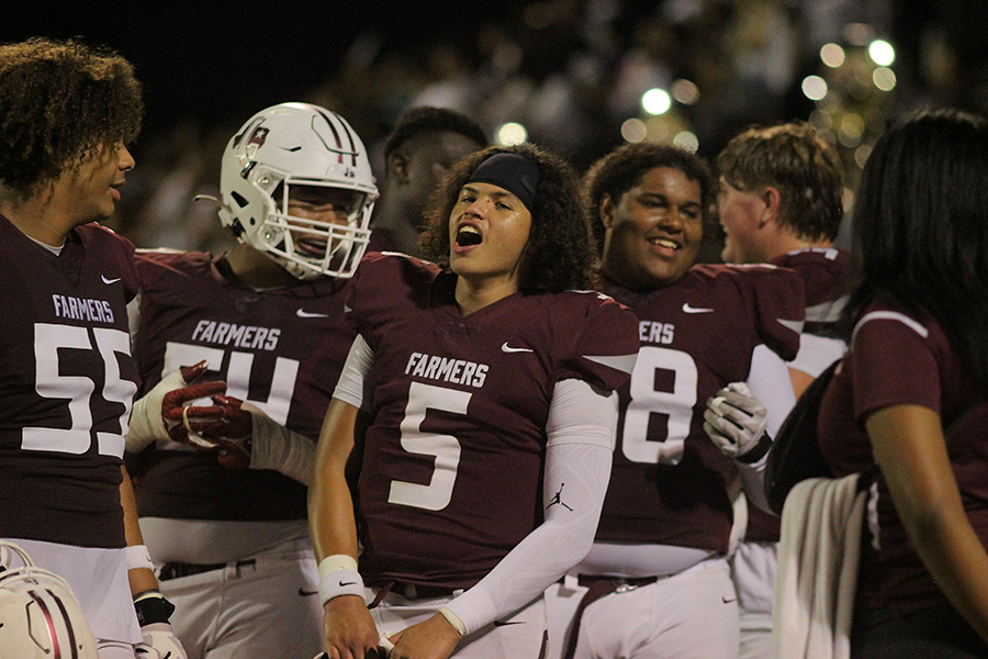 Junior Aidan Murphy, freshman 
Maxx Jones, sophomore Tre Williams and senior Kylan Masters hype each other up during the game.