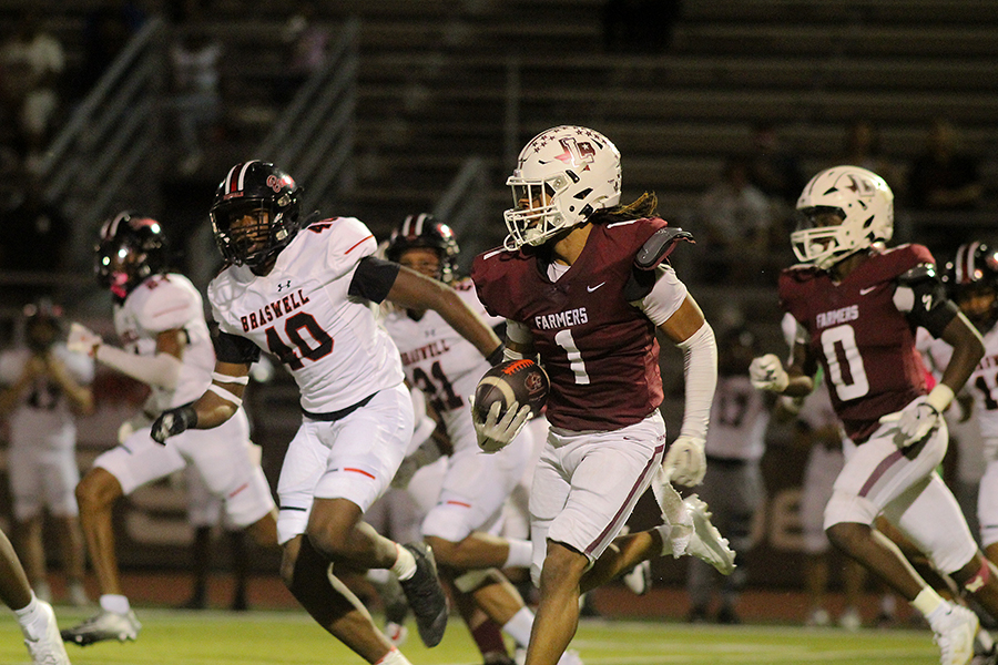 Senior D'Angelo King returns a punt while avoiding a Braswell defender. 