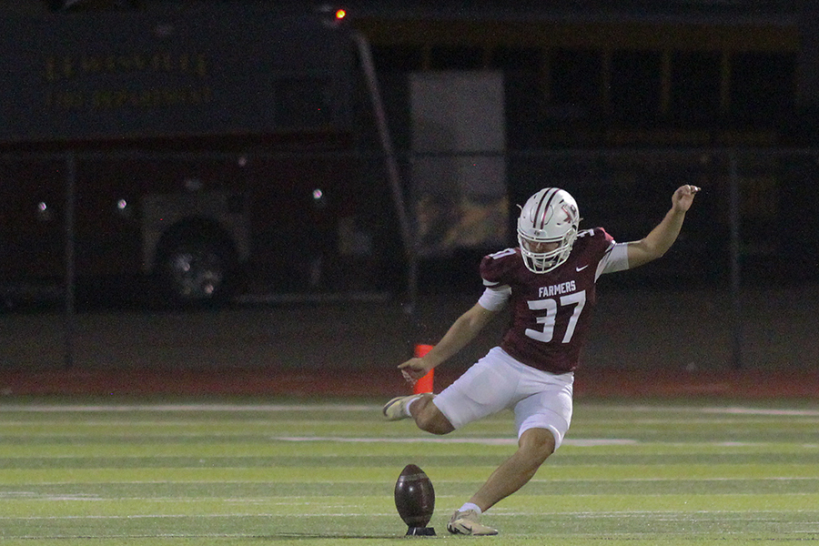 Senior Nathaniel Fraga kicks the ball to Braswell in the second half.