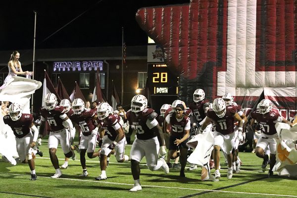 The Farmers run onto the field after halftime of the homecoming game on Friday, Oct. 4.