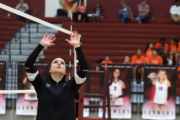 Sophomore Aubrey Dean warms up before the game against Haltom on Aug. 27. The Farmers won the game 3-0.