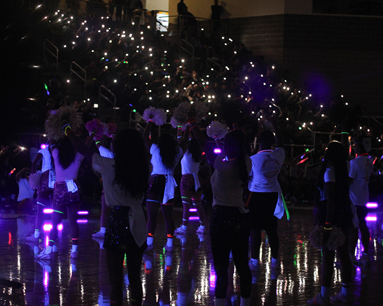 The student section lights up the arena with their cameras.