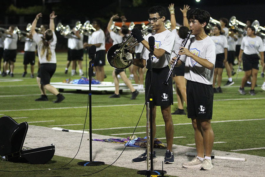 Senior Isaac Flietas and sophomore Tien Tran play their solos at the varsity football game against Rockwall on Friday, Sept. 13.