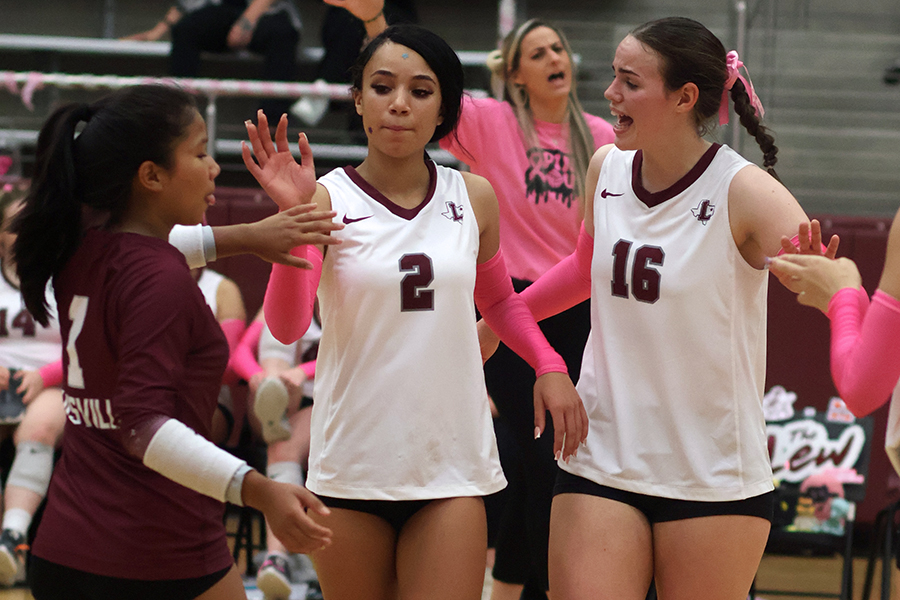 Senior Sui Par, junior Natalya Becker and senior Shannon Skinner celebrate after a play against Marcus on Oct. 8.