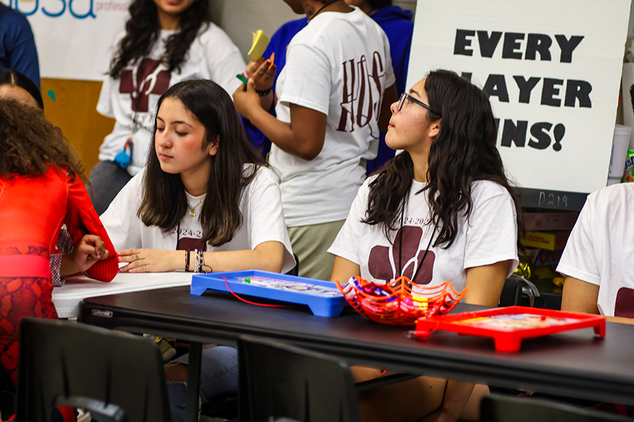 Junior HOSA members Karla Victoria and Camila Faustino help children play Operation to earn prizes. 