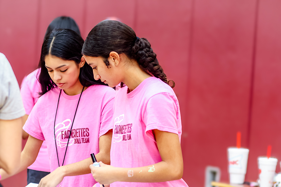 Sophomore Rosie Espino and junior Geraldine Polanco volunteer for the Farmerettes booth.