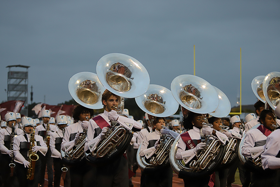 The sousaphone section marches during the football game. 