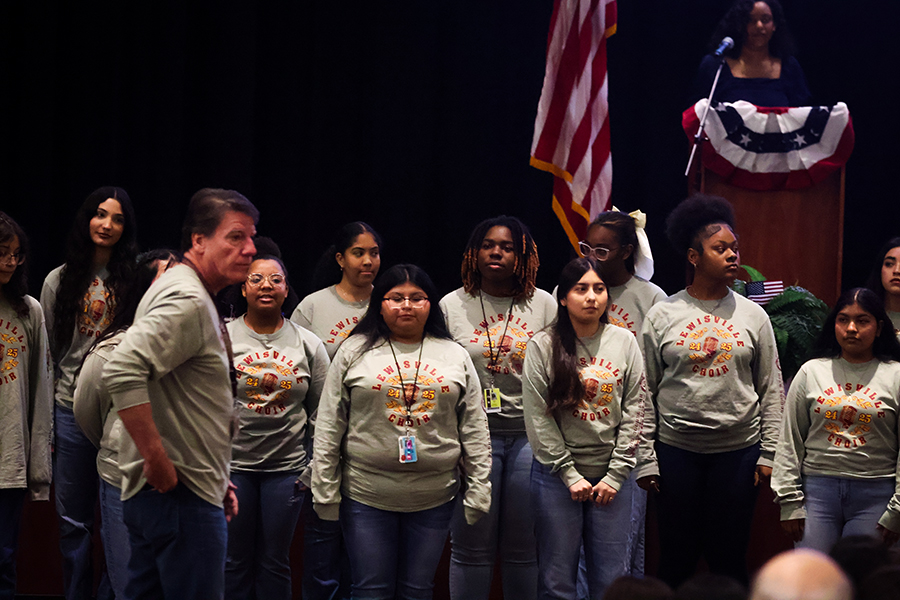 Cantori choir members prepare with head director, Steve DeCrow to sing the Star Spangled Banner. 