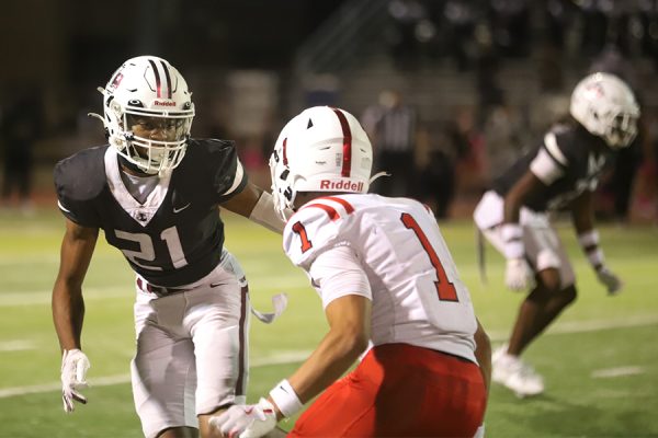 Junior cornerback Kanye Anderson guards senior wide receiver Tucker Cusano during the Coppell game on Friday, Oct. 18.