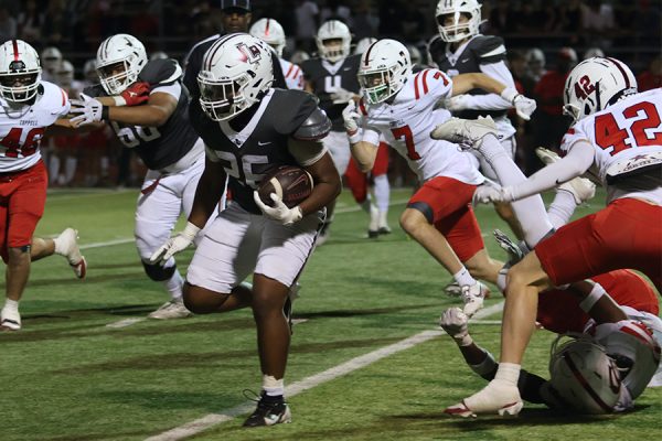 Senior running back Isaiah Wilson (26) breaks away from Coppell defenders during the fourth quarter.