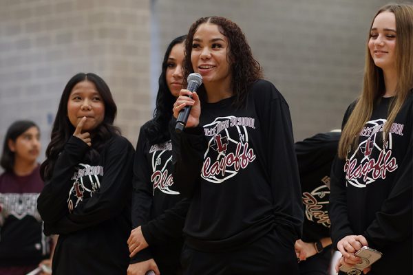 With the rest of the varsity volleyball team standing by her side, senior Milan Norman speaks to the crowd at the pep rally on Friday, Nov. 1.