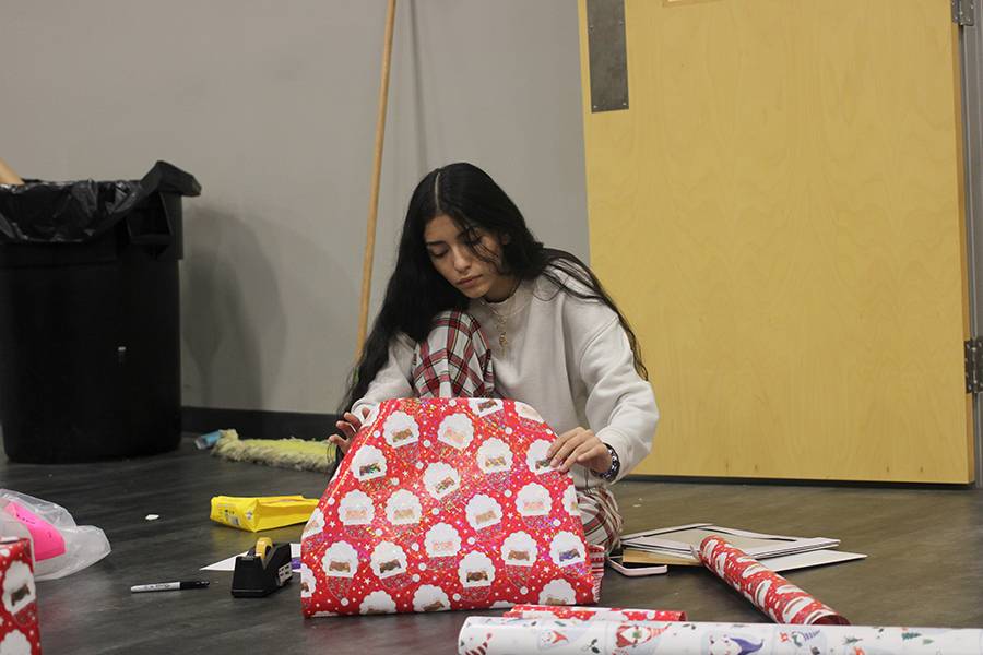 NHS president Julianna Narvaez carefully wraps a present. 