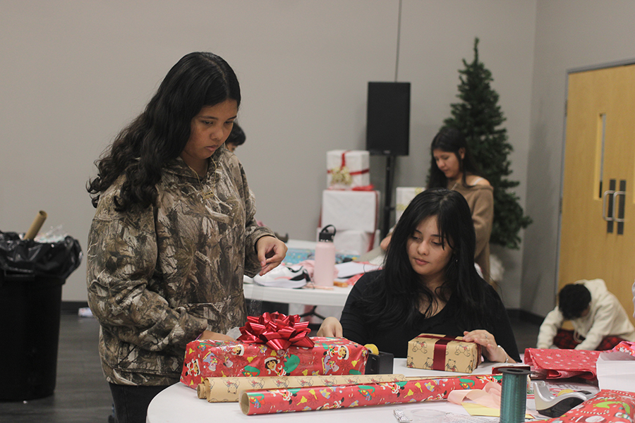 Senior Interact member Nathaly Romero and her sister Jacky wrap gifts for angels. 