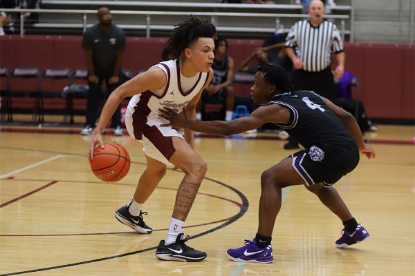 Junior Brayden Jones dribbles the ball up the court vs. Lincoln on Nov. 8. 