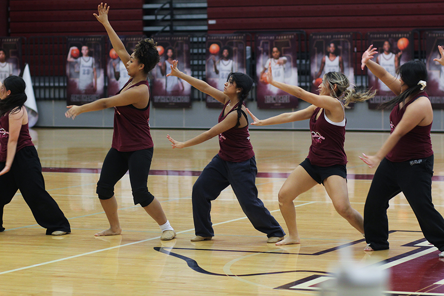 Freshman Jasmine Brown, sophomore Jocelyn Sanchez, sophomore Alina Charone and senior Jessica Martinez in the middle of elite contemporary.