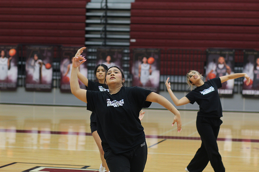 Junior Rosie Espino, sophomore Alina Charone and senior Jessica Martinez in the middle of elite contemporary. 