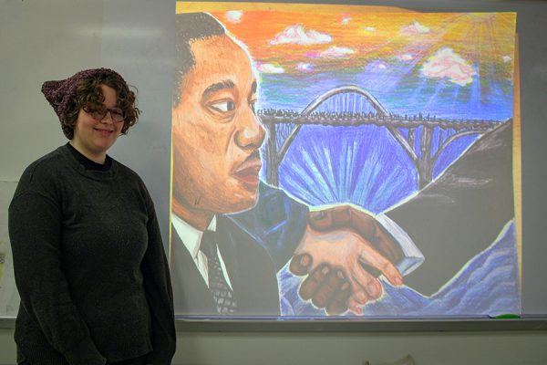 Isabelle Gourley stands in front of her MLK artwork 