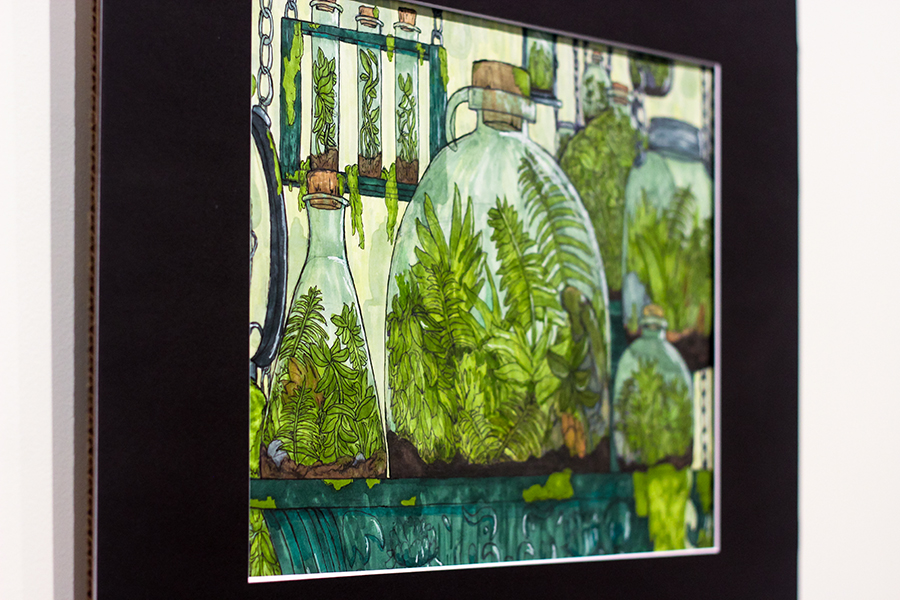 'Green Under Glass' is a mixed media artwork created by senior Luke Eckstein. The colors are symbolic for the message Eckstein is trying to convey. "I was going for a post-apocalyptic vibe," Eckstein said. "It's more toned in earthy green and it's more kind of eerie and peaceful to show that no matter what, the life [of] those plants will go on without us or not." 