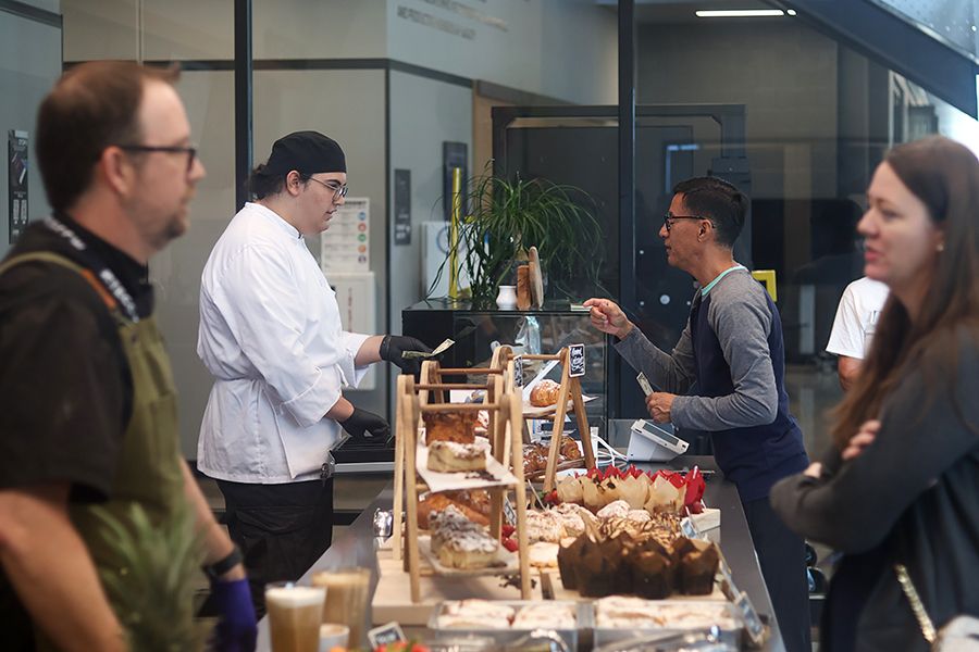 Sous-chef Corbin Harper helps a customer pay. 