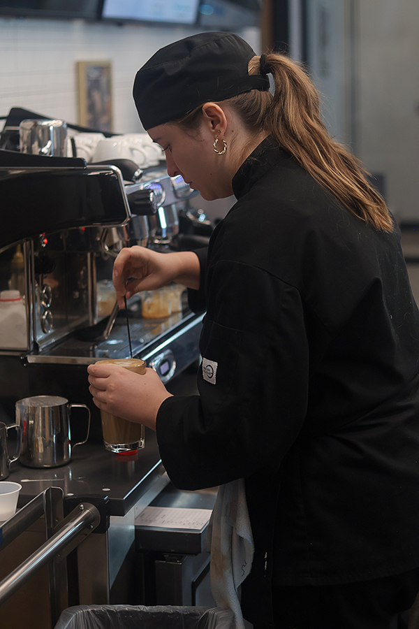 Advanced student Elin Petersun works as the barista for the cafe service.