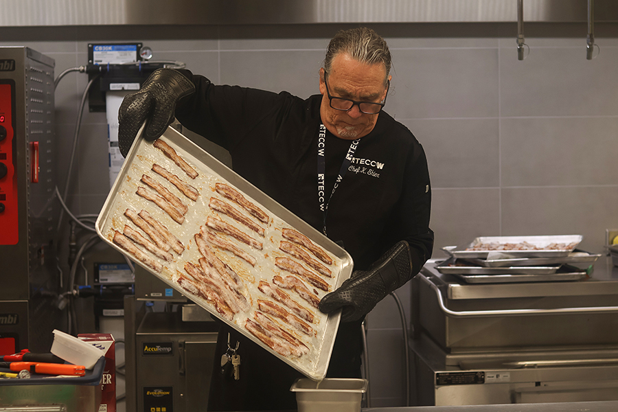 Chef Kenneth Shier drains the oil out of the bacon.
