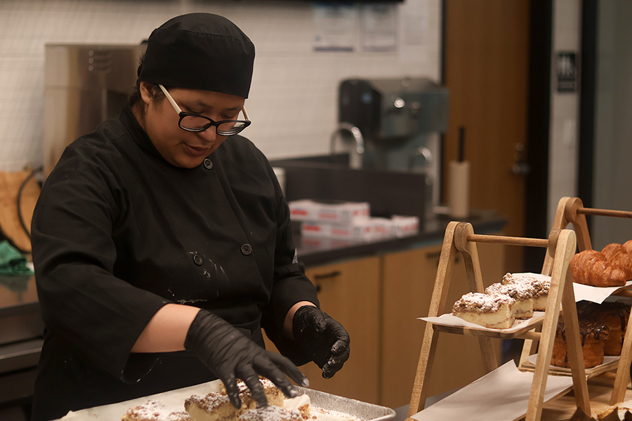 Advanced student Alondra Garcia plates the pastries.