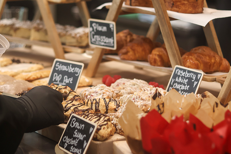 A variety of pastries are set out for cafe service customers.