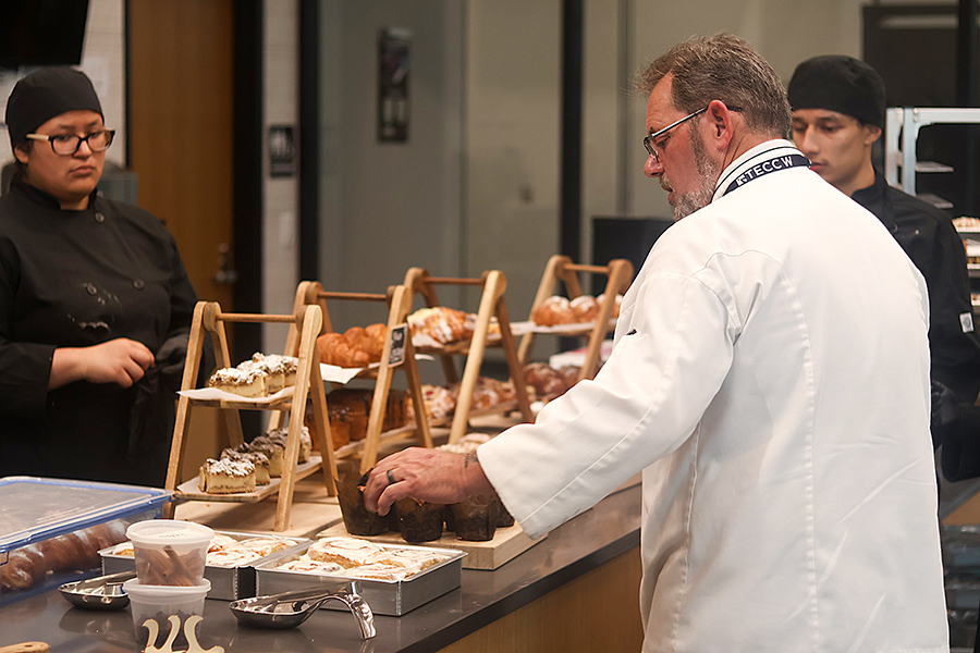 Chef Darron DeRosa verifies the pastry display to ensure everything is in place.