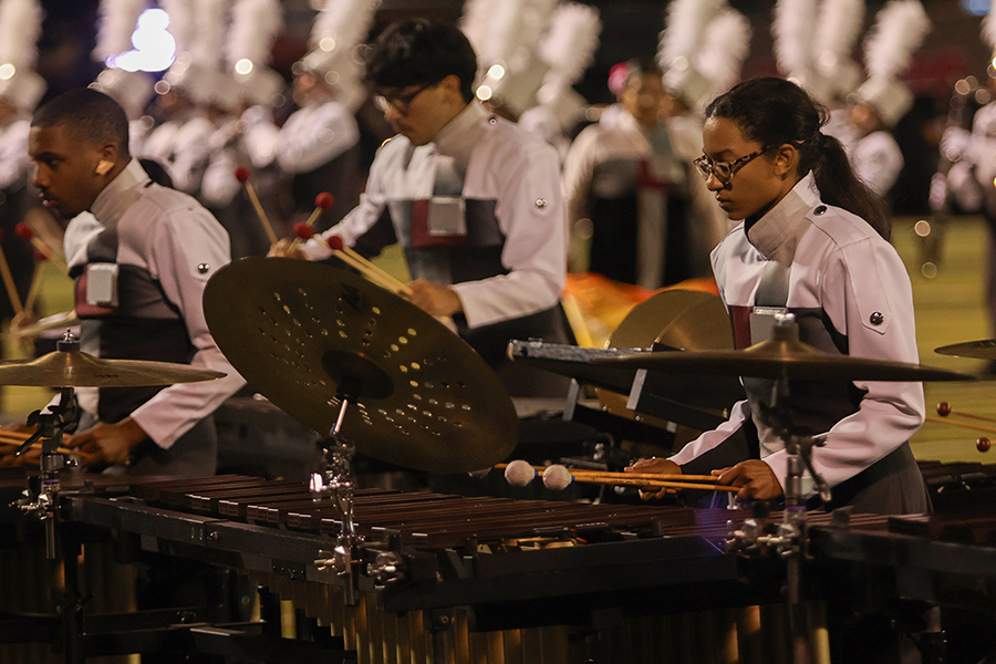 Seniors Zion Collie and Elizabeth Sabino perform during halftime with the front line ensemble. 