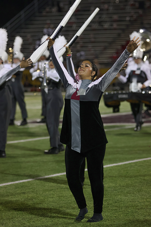 Junior Emma Lancaster performs with color guard during the halftime show. 