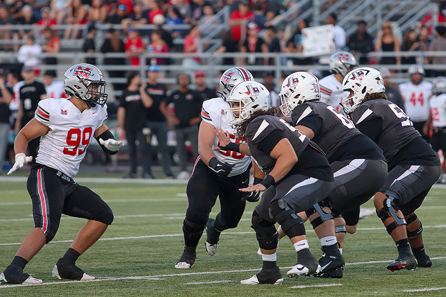 Senior Jonathan Sida prepares to block opposing players from advancing to give the quarterback enough time to make a play.
