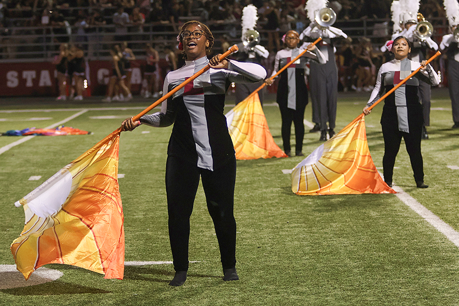 Senior Maiya Tennyson performs with color guard during halftime. 